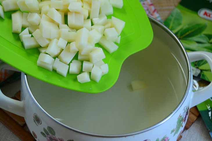 Summer fragrant soup with young cabbage and green peas