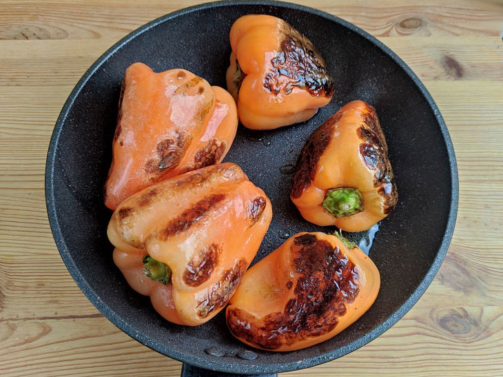 Fried peppers in a pan - a fragrant and spicy snack