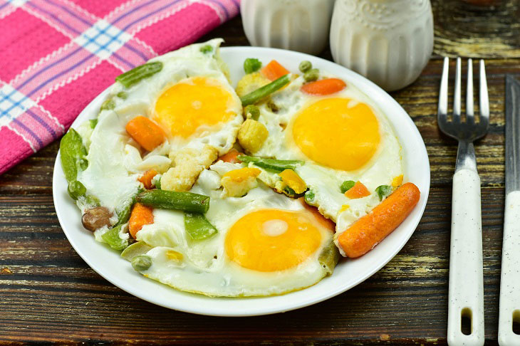 Fried eggs with vegetables in a pan - easy to prepare and very tasty