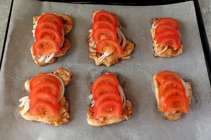 Chicken thighs with vegetables and cheese in the oven - tasty and appetizing