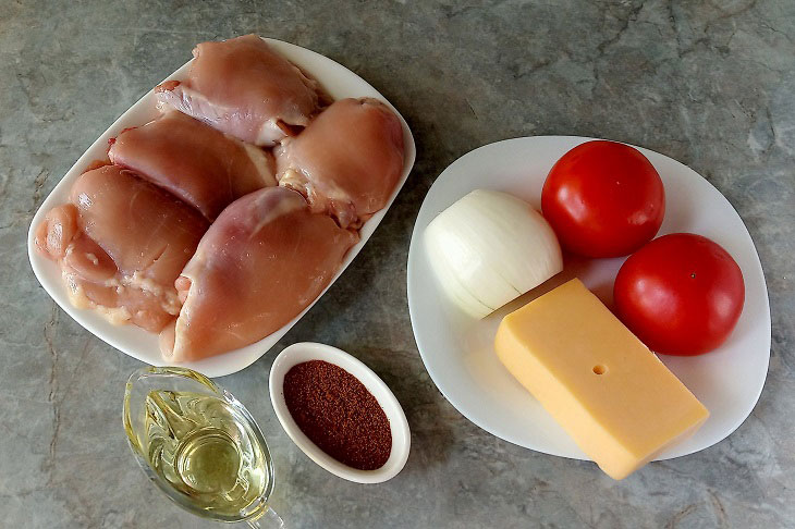 Chicken thighs with vegetables and cheese in the oven - tasty and appetizing