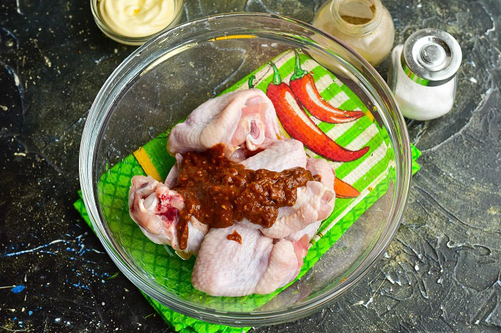 Chicken wings in adjika in the oven - delicious, quick and easy