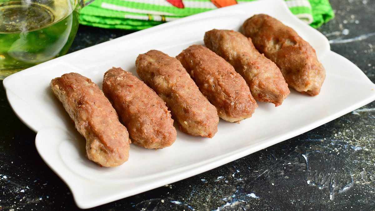 Fried meat sausages in a pan – juicy and fragrant