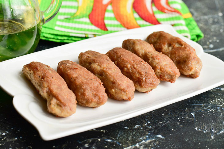 Fried meat sausages in a pan - juicy and fragrant