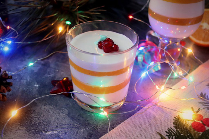 Festive dessert with an orange in a glass - light, delicate and airy