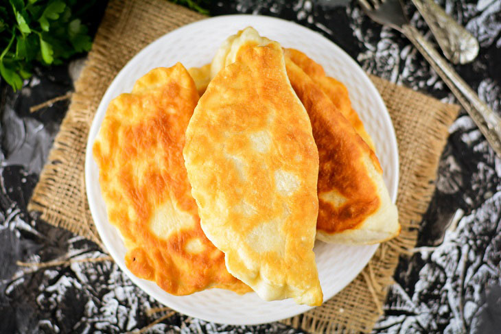 Homemade Gagauz pies with cabbage in a pan - lush and airy