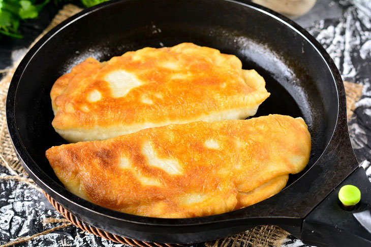 Homemade Gagauz pies with cabbage in a pan - lush and airy