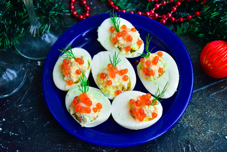 Stuffed eggs with red caviar - bright, beautiful and very tasty