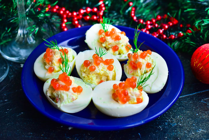 Stuffed eggs with red caviar - bright, beautiful and very tasty