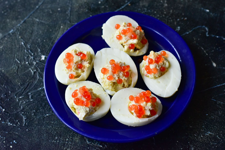 Stuffed eggs with red caviar - bright, beautiful and very tasty