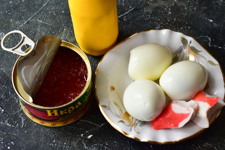 Stuffed eggs with red caviar - bright, beautiful and very tasty