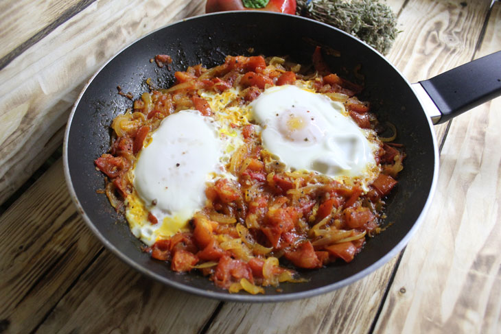 Israeli breakfast “Shakshuka” - fragrant scrambled eggs in tomato sauce