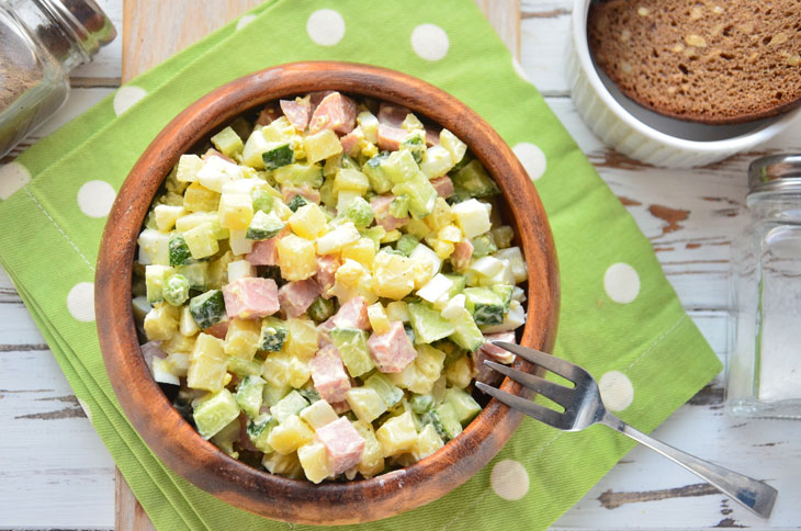 Summer "Olivier" with fresh cucumber and young peas