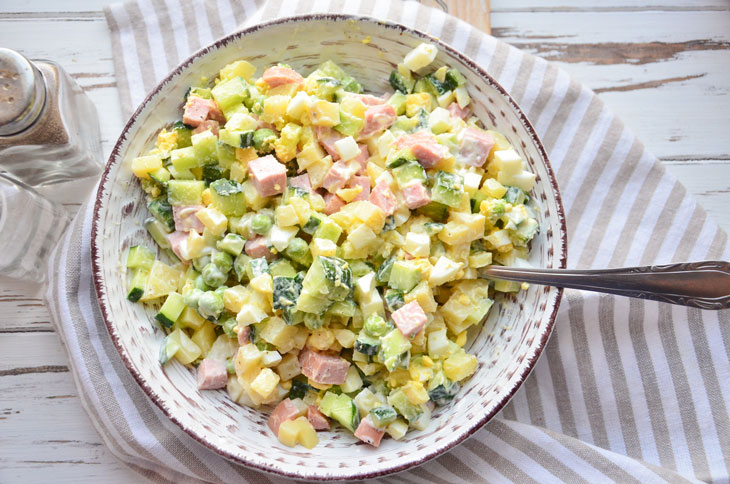 Summer "Olivier" with fresh cucumber and young peas