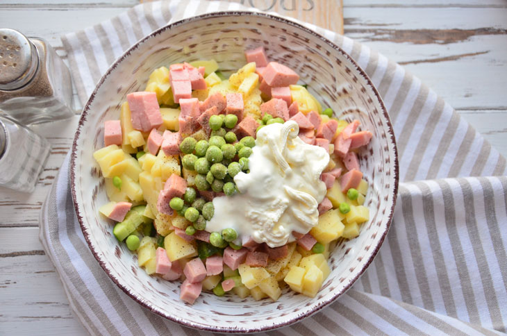 Summer "Olivier" with fresh cucumber and young peas