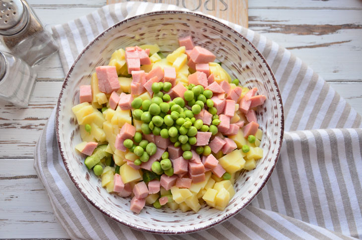 Summer "Olivier" with fresh cucumber and young peas