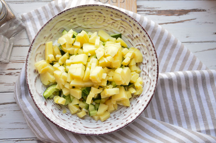 Summer "Olivier" with fresh cucumber and young peas