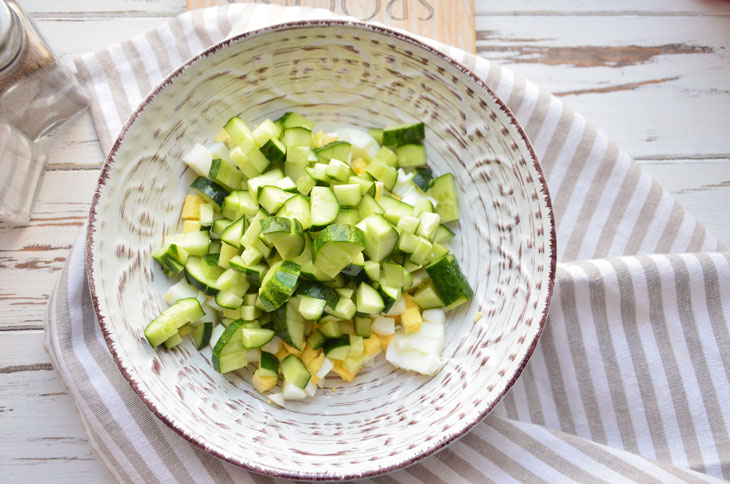 Summer "Olivier" with fresh cucumber and young peas