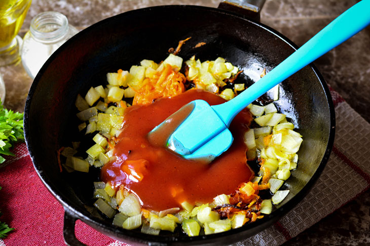 Zucchini stewed in tomato sauce in a pan - unusual and bright in taste