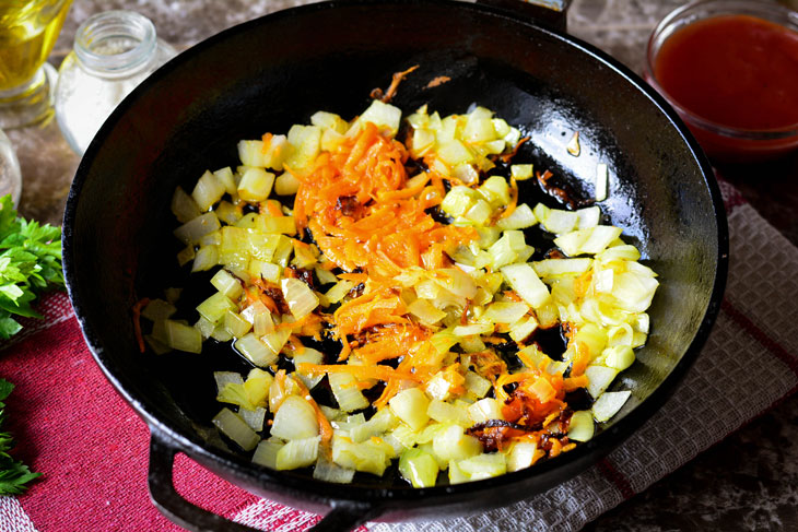 Zucchini stewed in tomato sauce in a pan - unusual and bright in taste