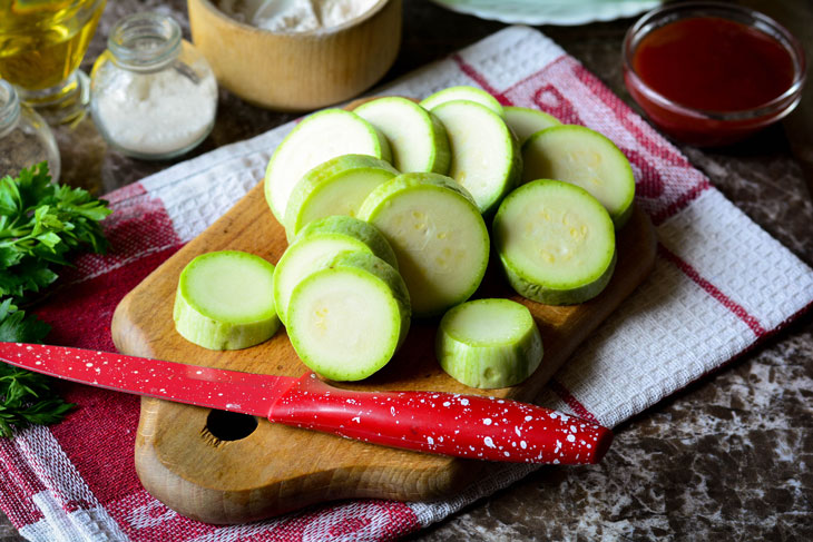 Zucchini stewed in tomato sauce in a pan - unusual and bright in taste