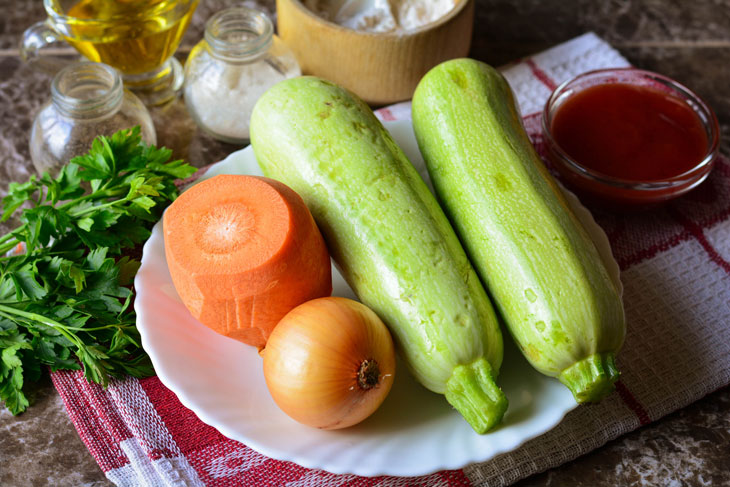 Zucchini stewed in tomato sauce in a pan - unusual and bright in taste